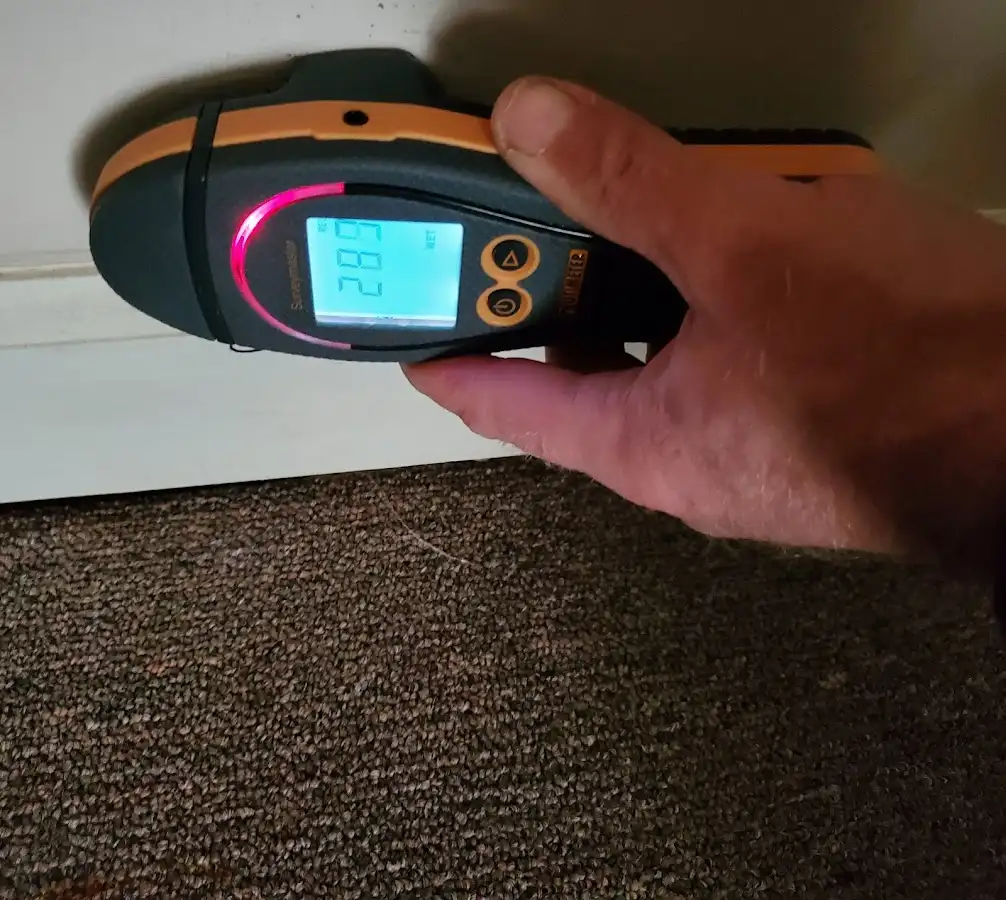Moisture detection at baseboard during Storm Damage Restoration in Archdale